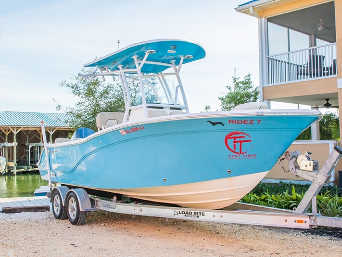 a small plane sitting on top of a blue wall