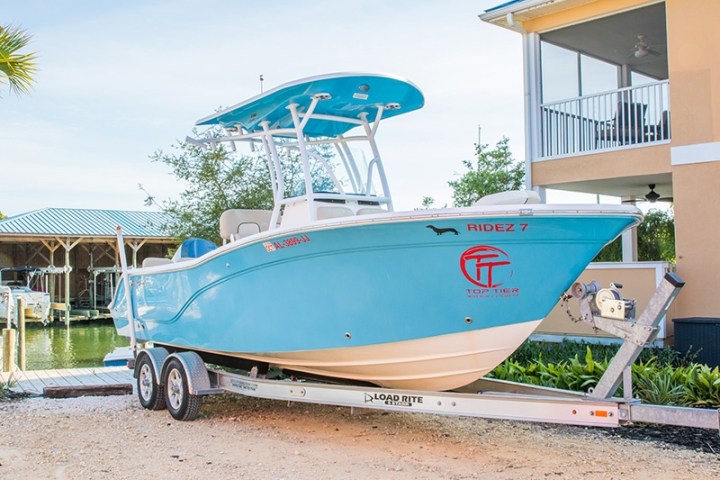 a small plane sitting on top of a blue wall