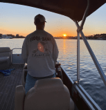 a person sitting in a boat on a body of water