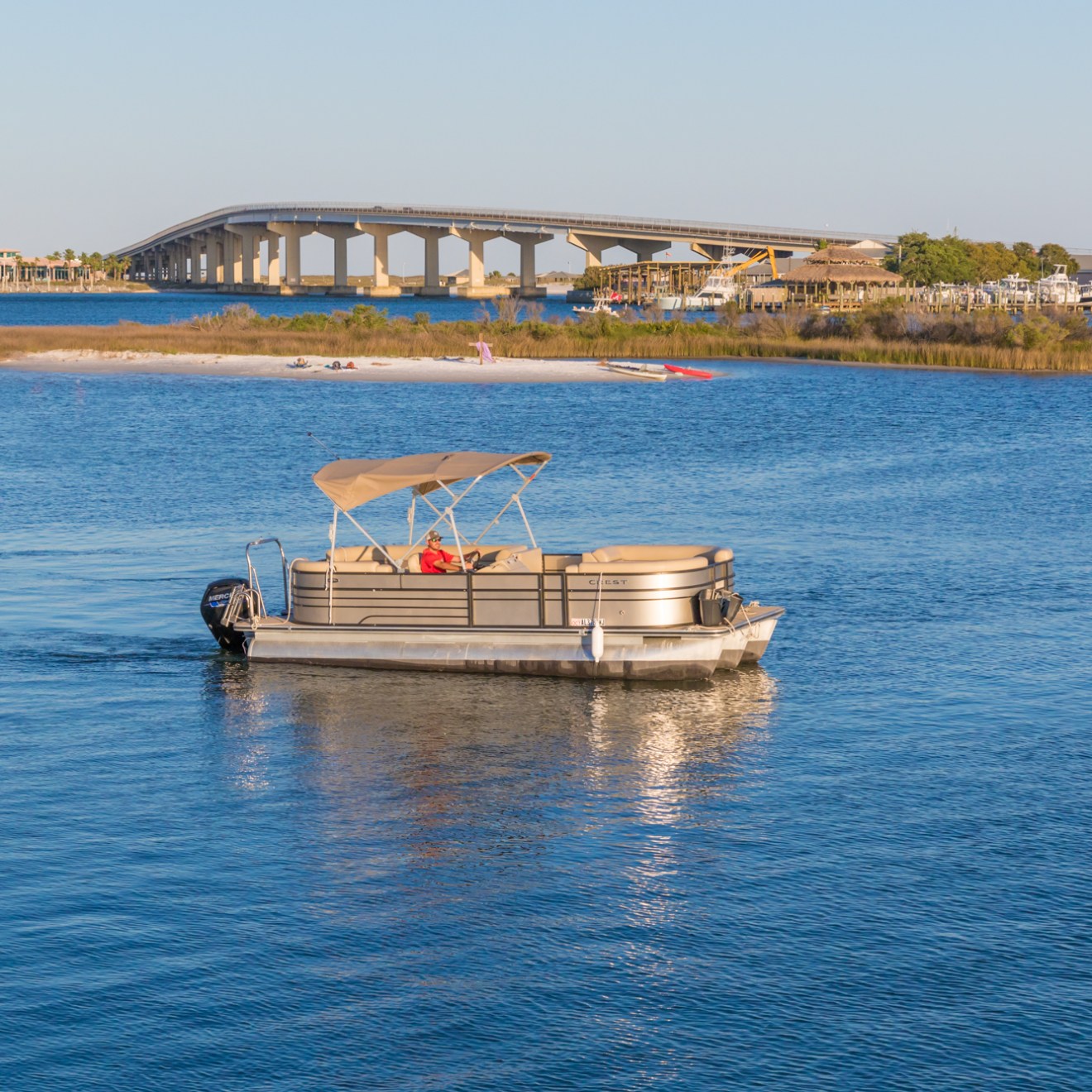 a boat traveling across a bridge over a body of water